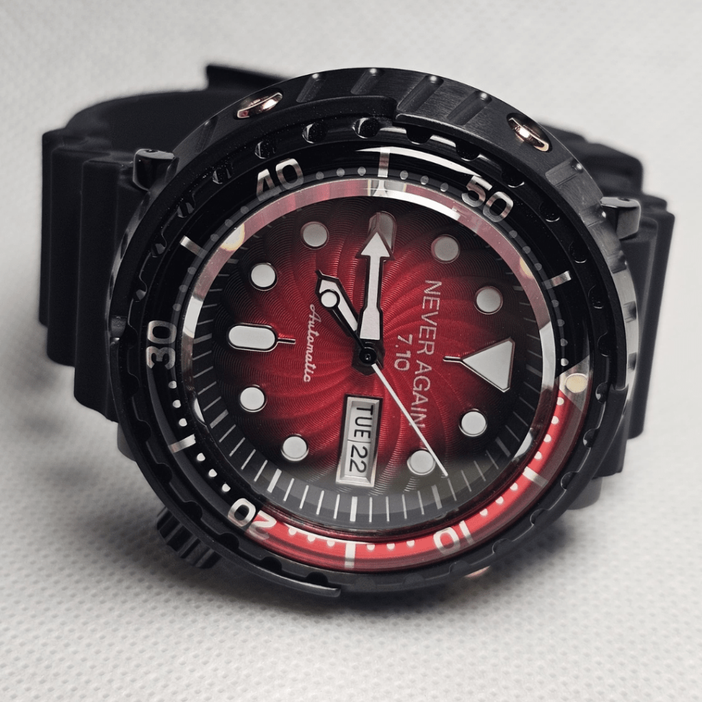 Seiko Tuna mod with red sunburst dial, black case, and “7.10 Never Again” laser engraving