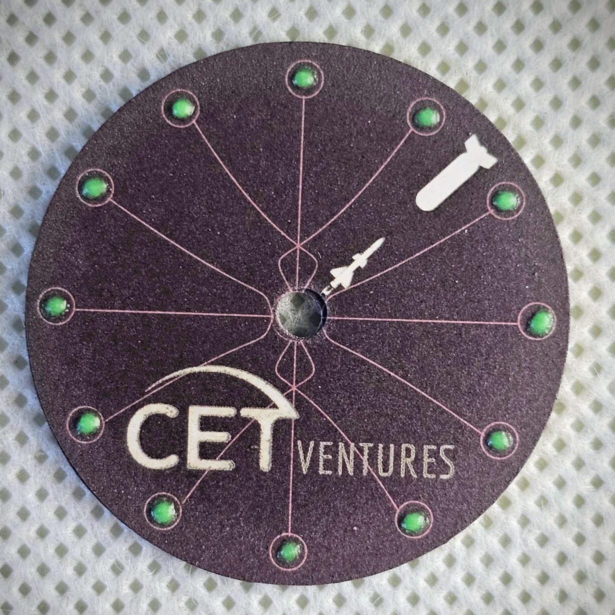 Handmade cardboard watch dial photographed in studio lighting