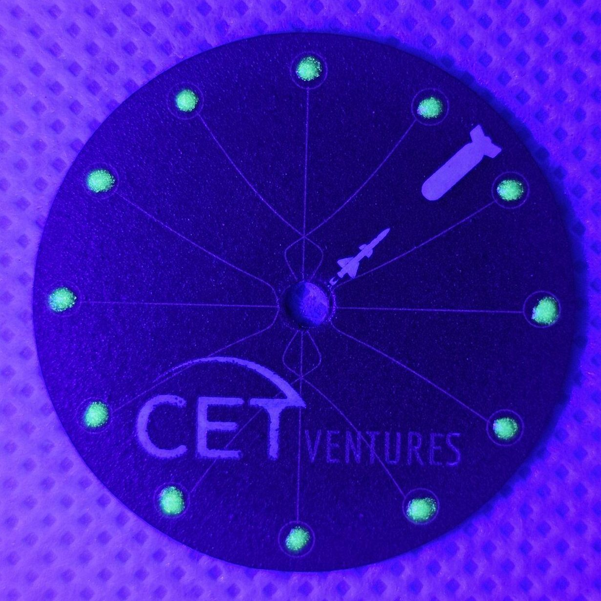 Handmade cardboard watch dial glowing in the dark with luminous markers