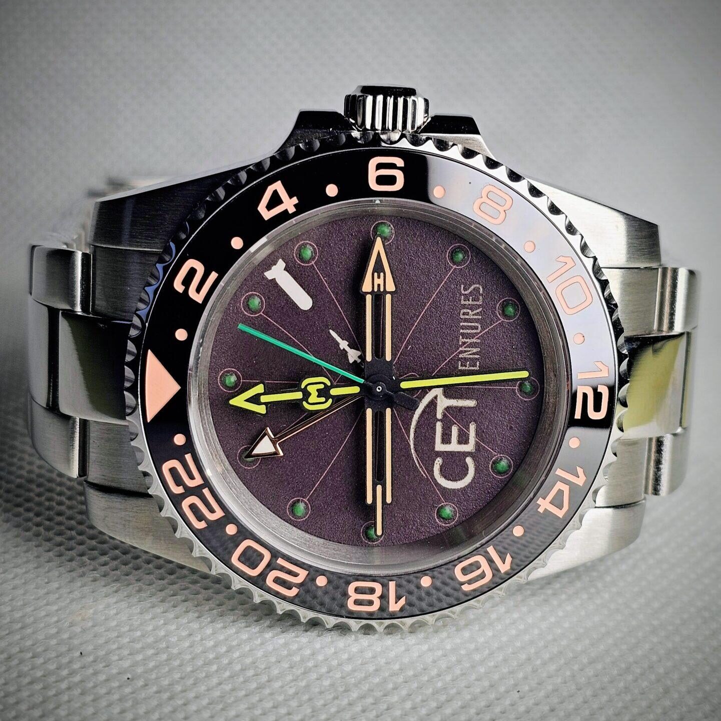 Custom submariner style watch with handmade cardboard dial photographed in studio lighting