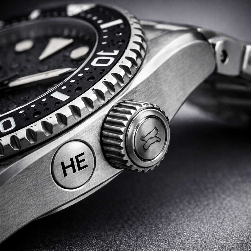 Side view of a dive watch case showing a helium escape valve used for saturation diving