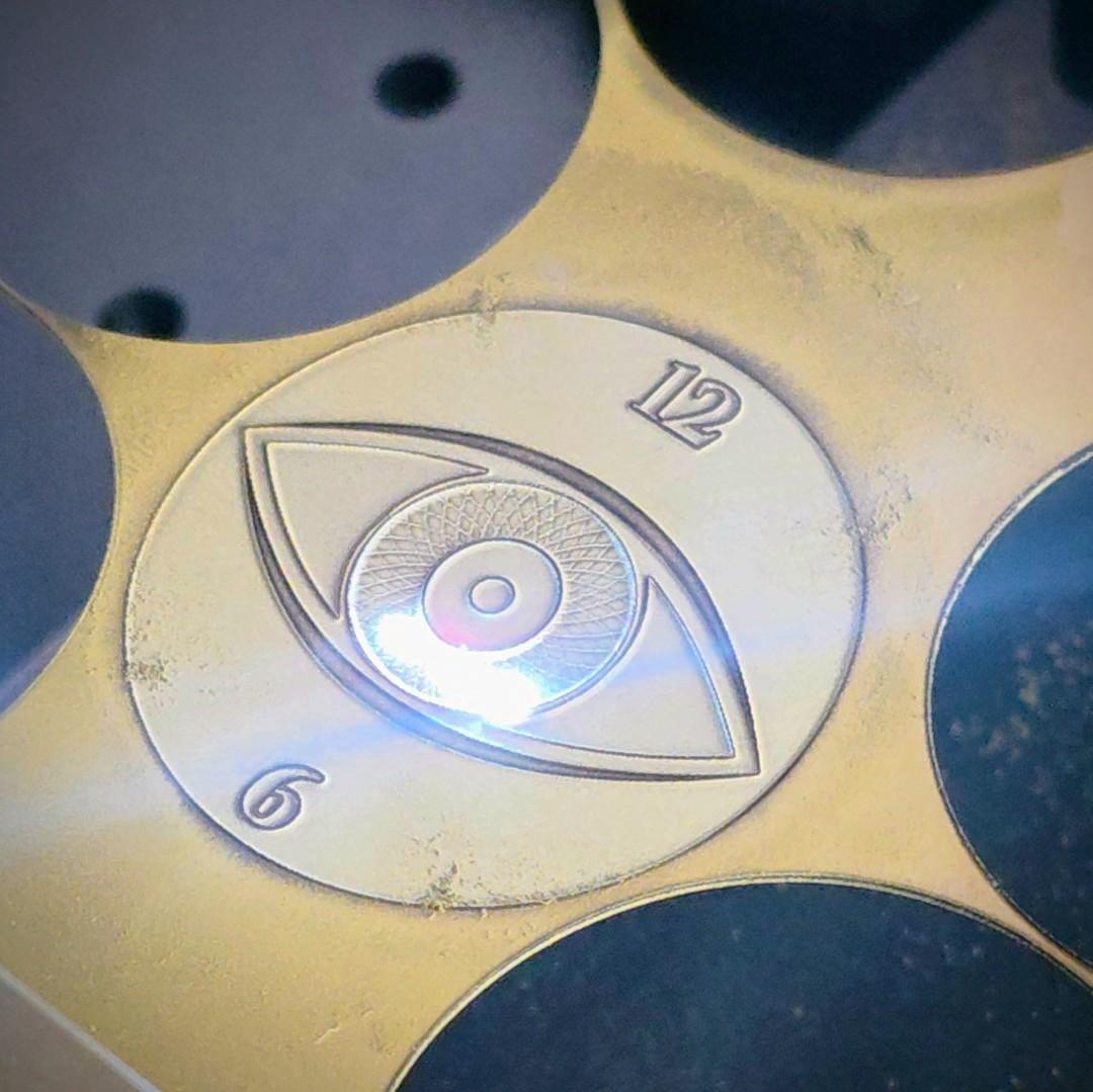 laser engraving process used to create a textured brass watch dial