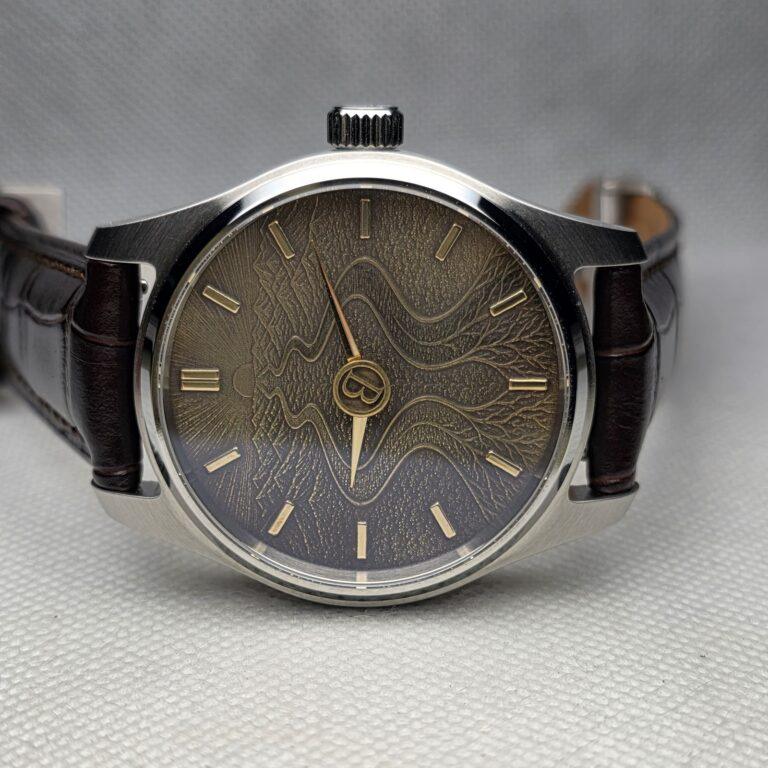 Custom milestone watch with a root-like textured dial and restrained central monogram