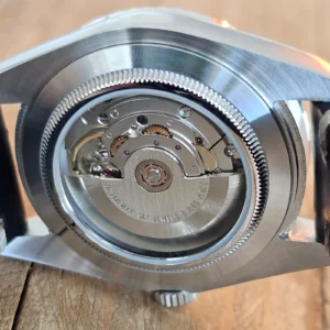 Sellita SW200-1 automatic movement visible through a watch caseback for a Sellita SW200-1 vs NH35 comparison