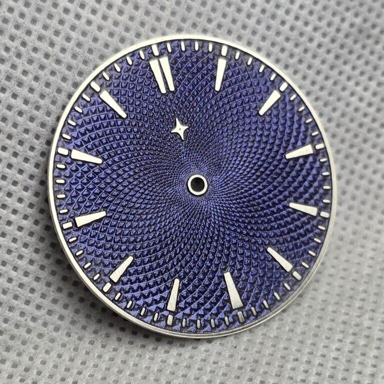 Blue-purple Chameleon dial with an engraved pattern, raised hour markers and a small star