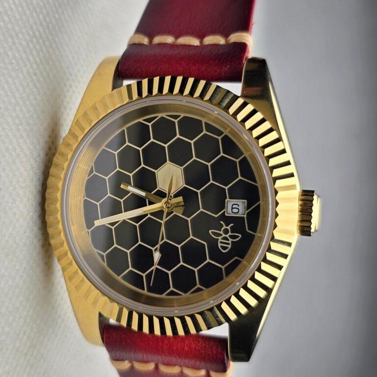Finished Honeycomb watch with a gold-tone case, dark honeycomb dial and burgundy leather strap
